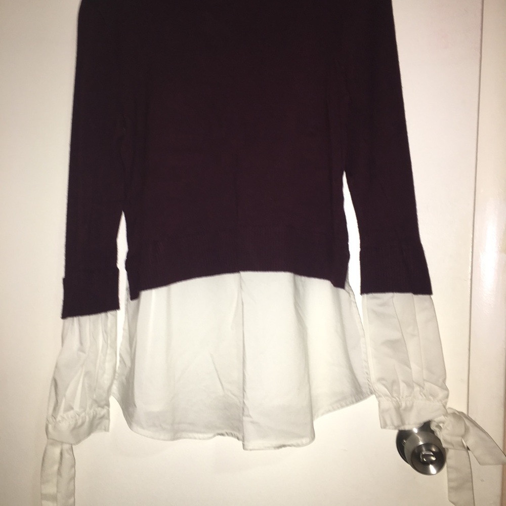 a white and purple long sleeve tee